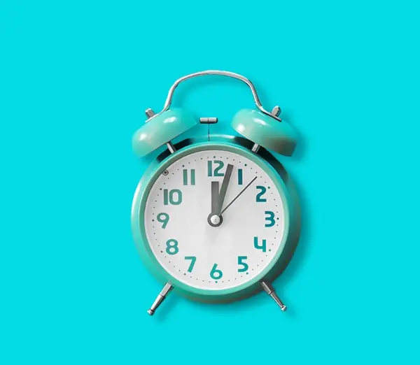 A blue alarm clock on a blue background