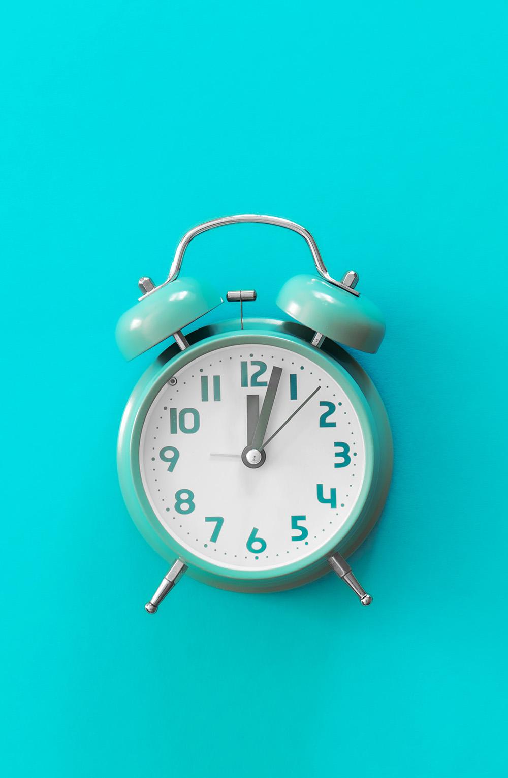 An alarm clock on a blue background