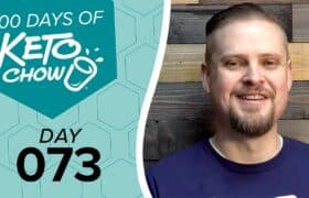 Teal KETO CHOW graphic: 100 DAYS OF KETO CHOW text, blender bottle logo, DAY 073. Smiling bearded man in blue shirt to the right.