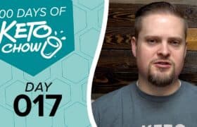 Branded teal graphic for 100 DAYS OF KETO CHOW featuring the shaker bottle logo and DAY 017. A man with a goatee in a grey shirt appears on the right against a dark wood panel background.