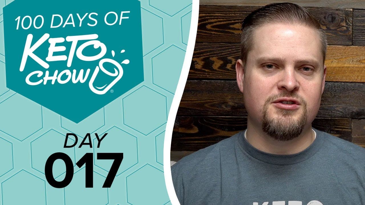 Branded teal graphic for 100 DAYS OF KETO CHOW featuring the shaker bottle logo and DAY 017. A man with a goatee in a grey shirt appears on the right against a dark wood panel background.