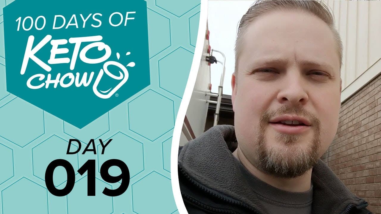 Graphic: 100 DAYS OF KETO CHOW logo, DAY 019 text, on teal and light blue-green hexagons. Right side shows a man.