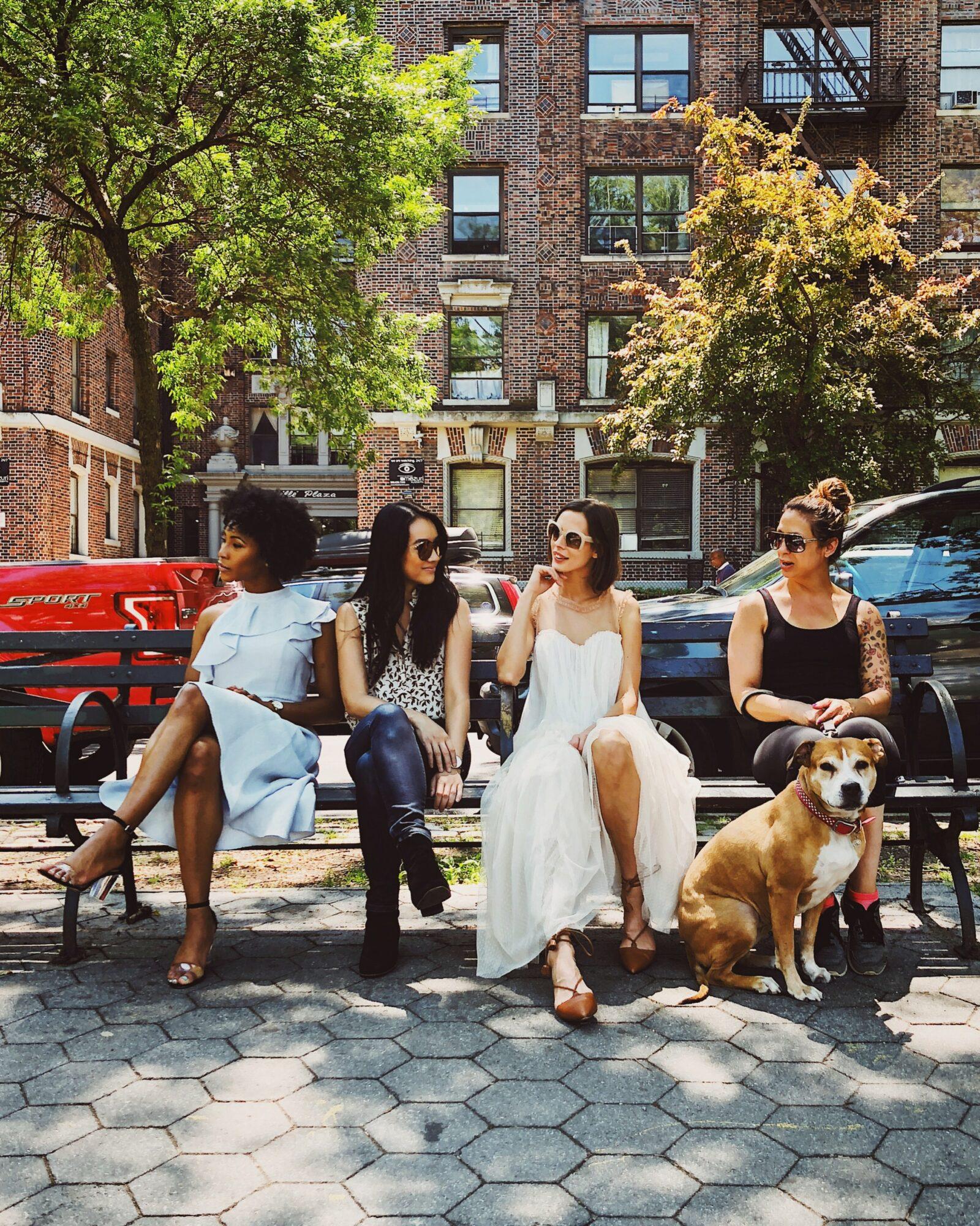 women sitting on bench