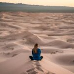 woman sitting in sand