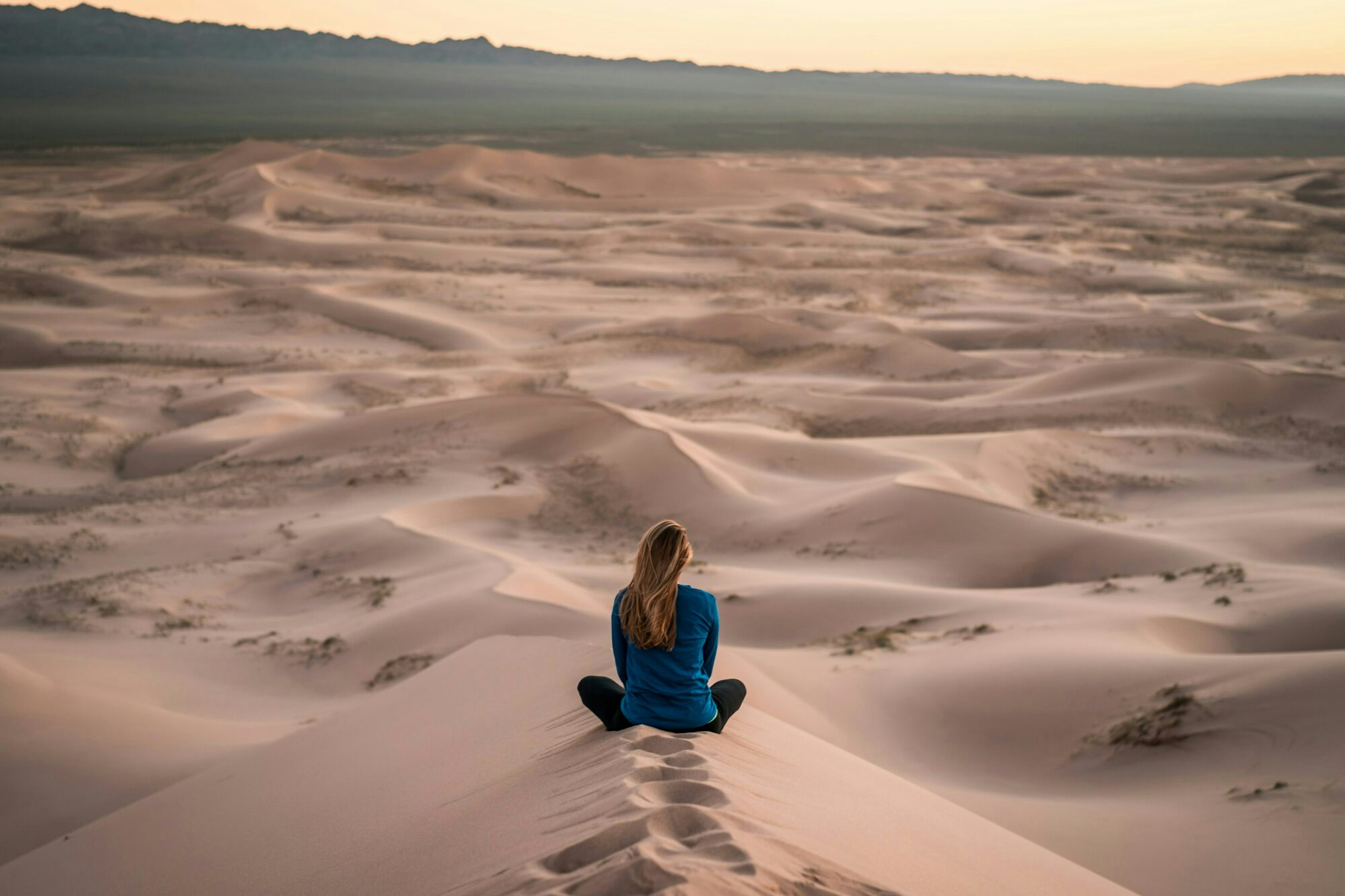 woman sitting in sand