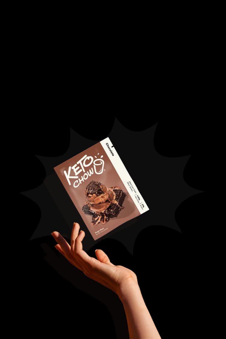 A hand throwing a single pack of Chocolate Keto Chow.