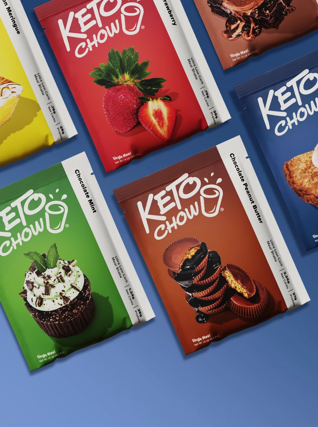 A variety of Keto Chow single-serving meal mix packets arranged diagonally against a royal blue background. Visible flavors include Lemon Meringue, Strawberry, Chocolate Mint, Chocolate Peanut Butter, and Blueberry Pie.