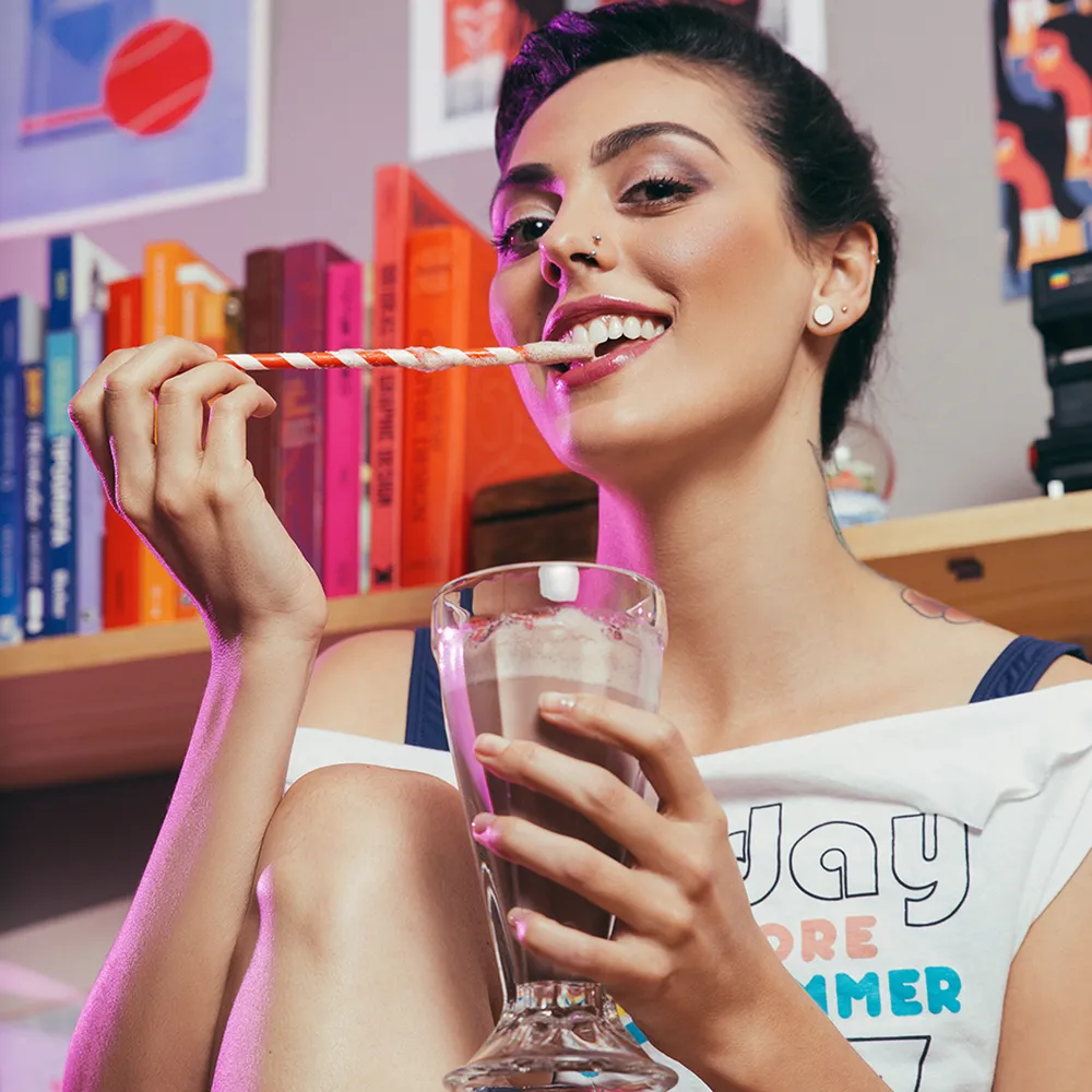 A woman eating a chocolate shake