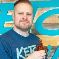 A picture of Chris Bair holding a boquet of bacon.