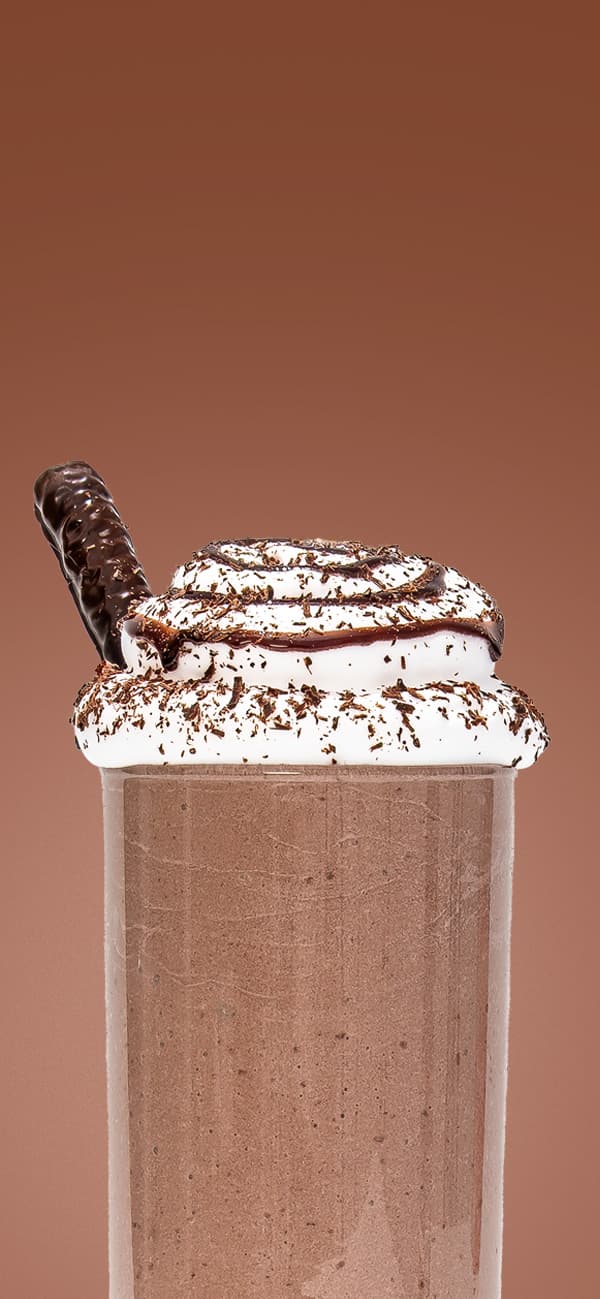 A chocolate Keto Chow shake on a brown background
