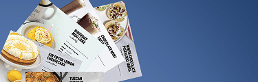 Three recipe cards on a blue background are titled: Air Fryer Lemon Cheesecake, Birthday Mug Cake, and Chocolate Mint Mousse. Also visible is a portion of a recipe card for Tuscan Chicken and White Chocolate Raspberry Tarts.