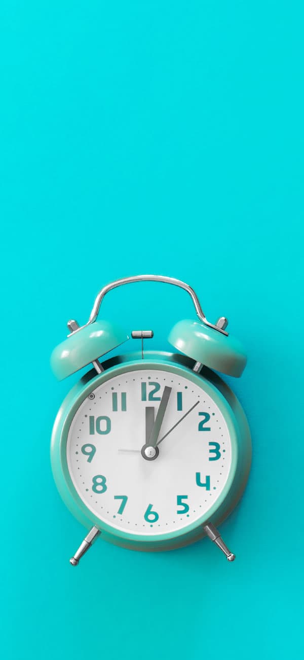 A blue alarm clock on a blue background