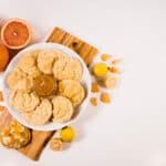 Guava Grapefruit jelly on a keto cookie, with a plate of cookies to the side..