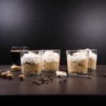 Four dessert cups filled with with Pumpkin Spice Latte Peanut Butter Mousse, topped with whipped cream.