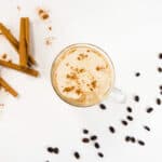 Cinnamon sticks, vanilla beans, and a Glass mug with Cafe au Lait