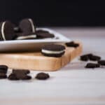 Close up - White plate filled with Dark Chocolate Cookie Crumbs.